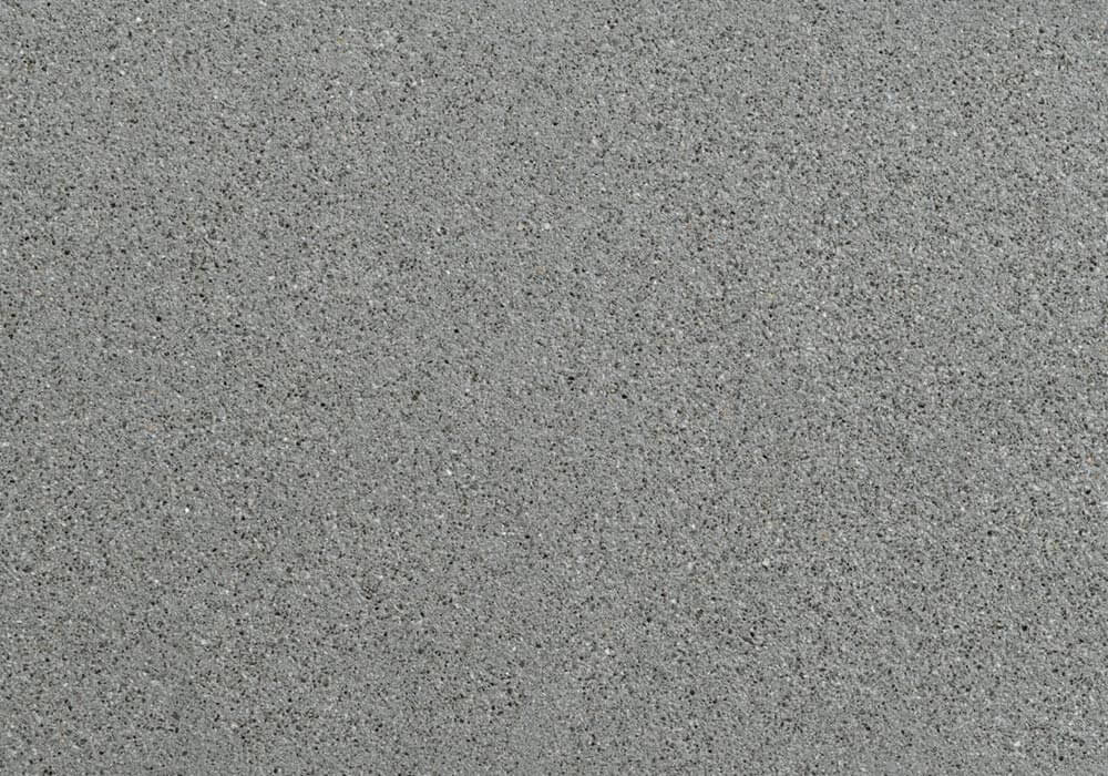 Textured concrete surface resembling natural stone in a sleek gray finish.