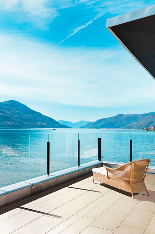 Terrassenplatte METTEN SPRING SORENO Toscanabeige auf einer eleganten Terrasse mit Blick auf den See und die Berge